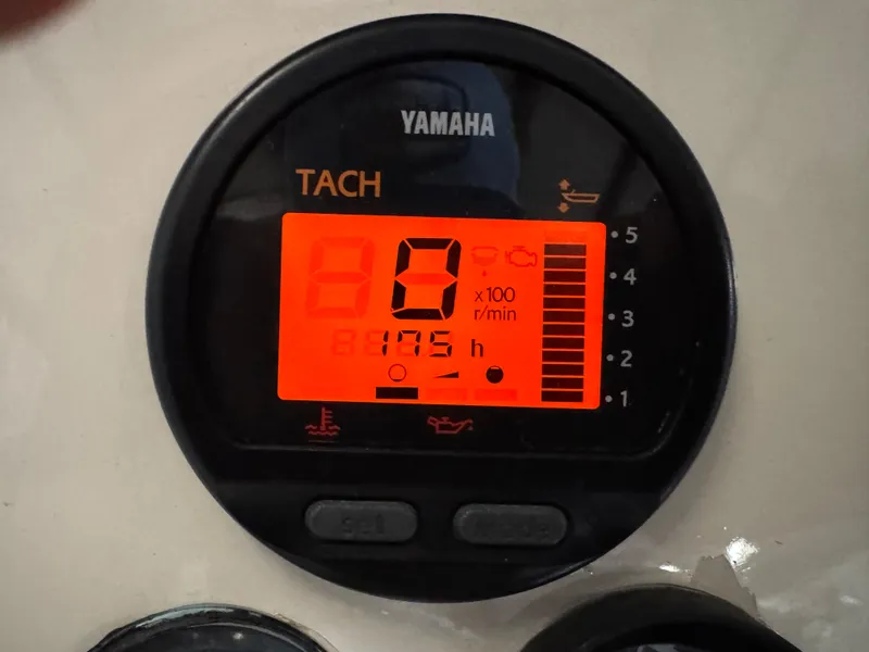 Slide: The Image of Yamaha tachometer displaying engine RPM and hours on a Custom Biddison 2200, 1987 model. - 19