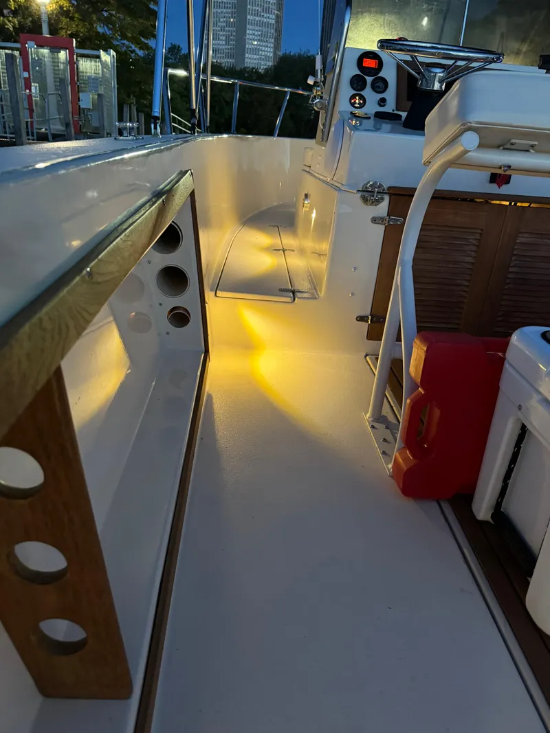 Slide: The Image of Interior of a 1987 Custom Biddison 2200 boat with ambient lighting. - 5