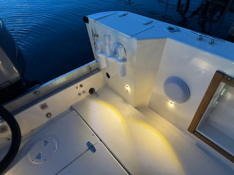 Slide: The Image of Interior of a 1987 Custom Biddison 2200 boat with ambient lighting and rod holders. - 9