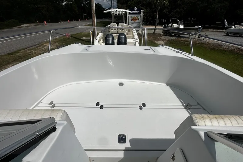 Slide: The Image of 2006 Glacier Bay 2600 boat deck with dual engines, parked near a road. - 10