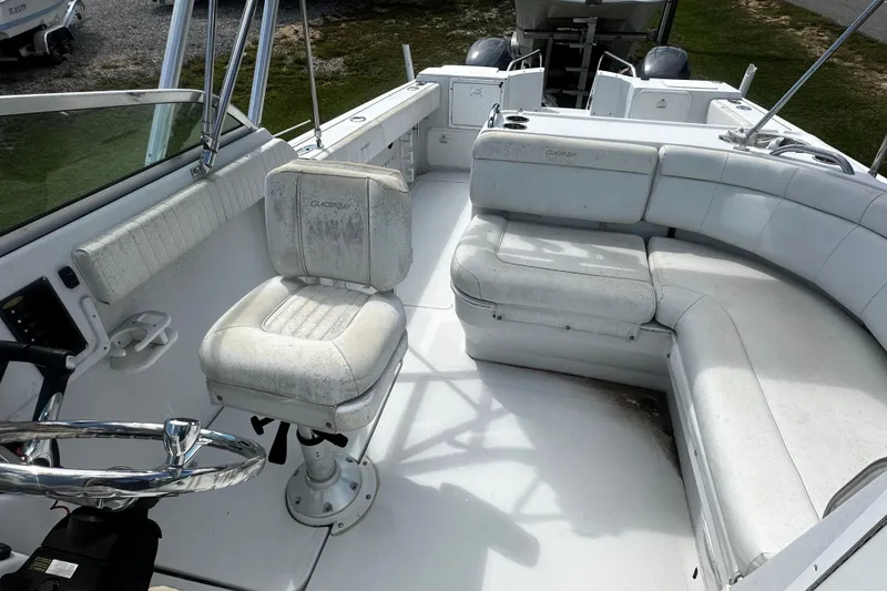 Slide: The Image of 2006 Glacier Bay 2600 boat interior with white seating and steering wheel. - 11