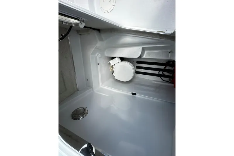 Slide: The Image of Interior of 2006 Glacier Bay 2600 boat, featuring a compact marine toilet. - 12