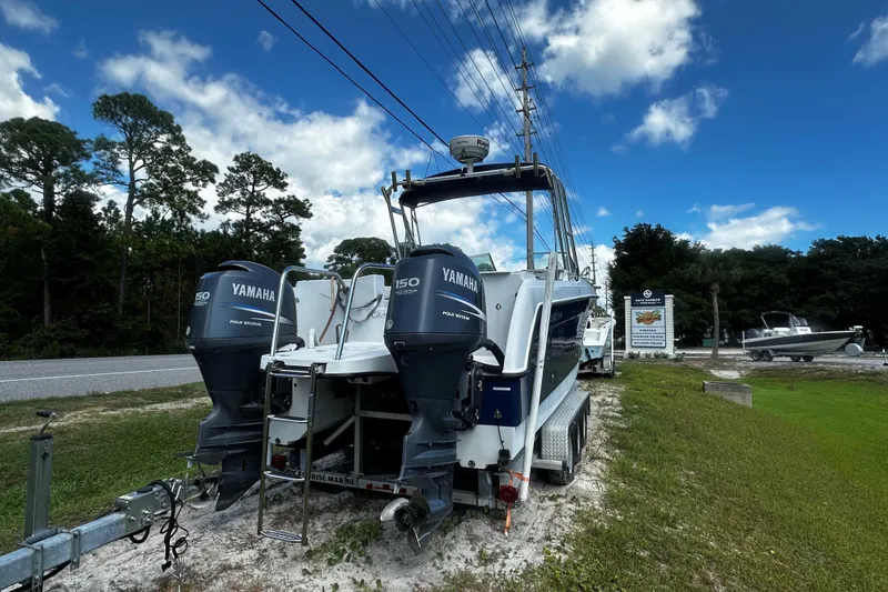 Slide: The Image of 2006 Glacier Bay 2600 boat with dual Yamaha engines on a trailer, parked roadside. - 13