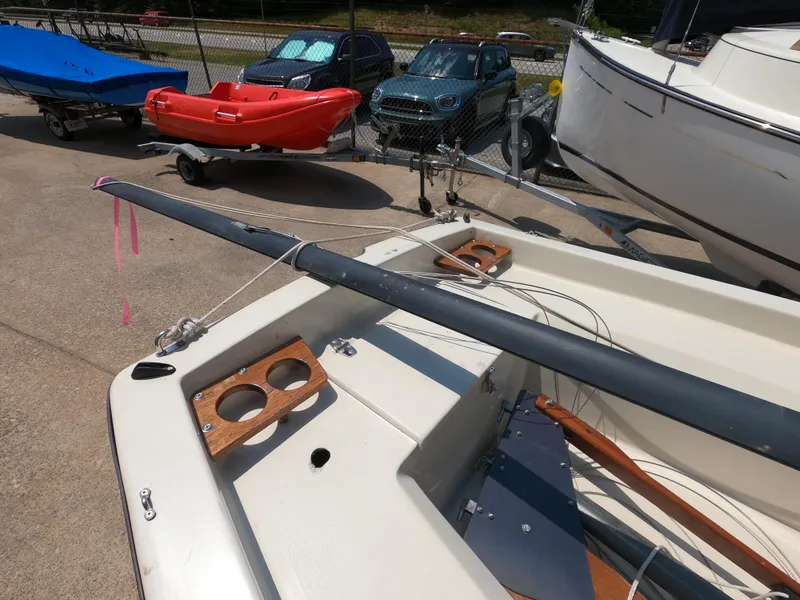 Slide: The Image of 1980 Spindrift Rascal 14 sailboat on trailer, with visible mast and wooden cup holders. - 7