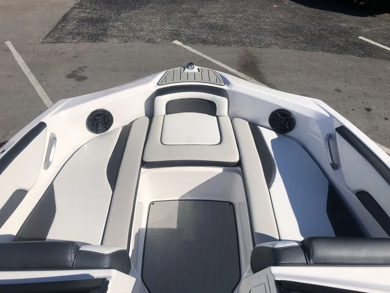 Slide: The Image of 2023 Yamaha Boats AR195 interior with sleek seating and speakers. - 4