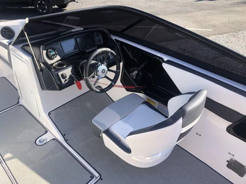 Slide: The Image of 2023 Yamaha Boats AR195 cockpit with steering wheel and dashboard controls. - 6