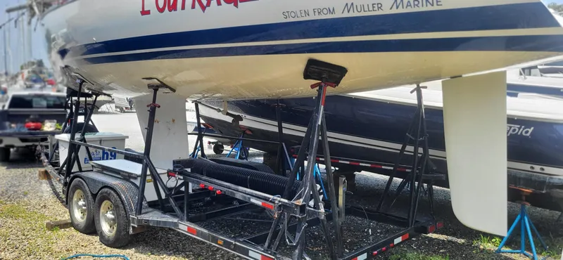 Slide: The Image of 1983 Beneteau First Class 10 sailboat on trailer, ready for transport. - 13