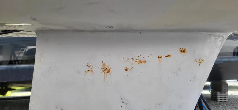 Slide: The Image of Keel of 1983 Beneteau First Class 10 sailboat with visible rust stains. - 15