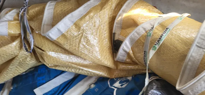 Slide: The Image of Rolled sail on a 1983 Beneteau First Class 10 yacht, featuring durable fabric and straps. - 8