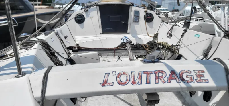 Slide: The Image of Cockpit of 1983 Beneteau First Class 10 sailboat, featuring "L'OUTRAGE" name. - 9
