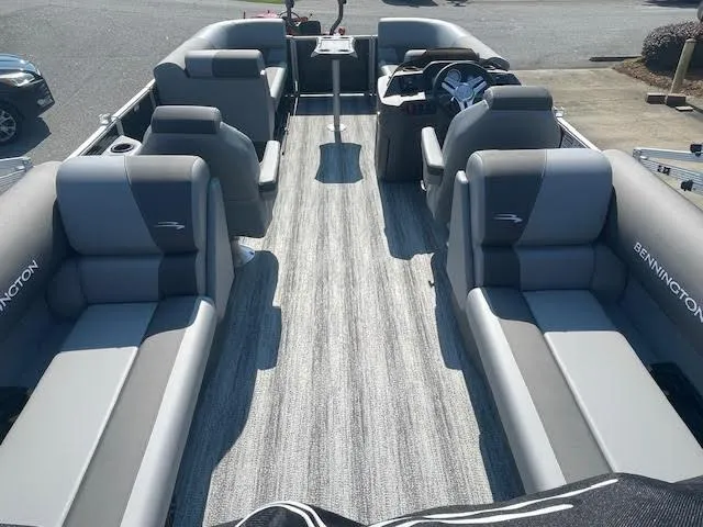 Slide: The Image of 2025 Bennington 22S pontoon boat interior with gray seating and modern steering console. - 3