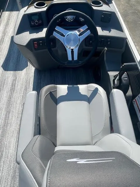 Slide: The Image of 2025 Bennington 22S boat interior with steering wheel and captain's chair. - 4