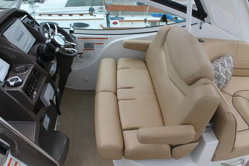 Slide: The Image of 2014 Cruisers Yachts 350 Express interior with beige seating and modern dashboard. - 12