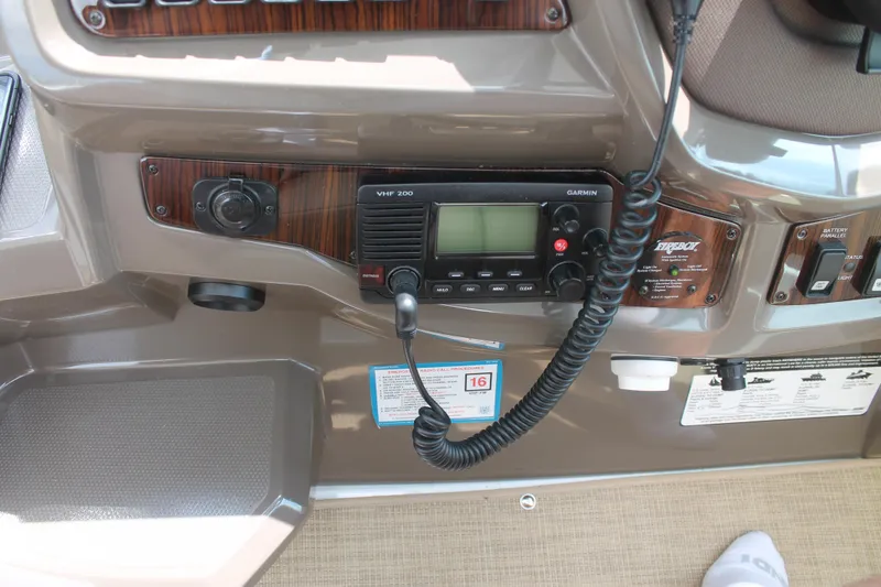 Slide: The Image of Control panel of 2014 Cruisers Yachts 350 Express with VHF radio and navigation controls. - 13