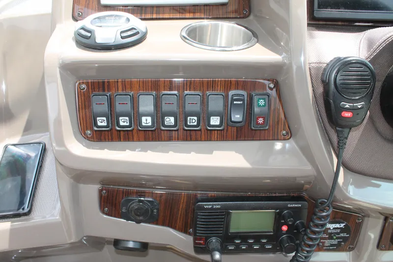 Slide: The Image of Control panel of 2014 Cruisers Yachts 350 Express with switches and radio equipment. - 14