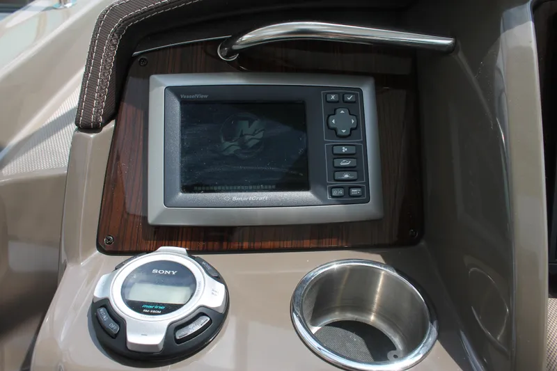 Slide: The Image of 2014 Cruisers Yachts 350 Express dashboard with navigation screen and cup holder. - 15