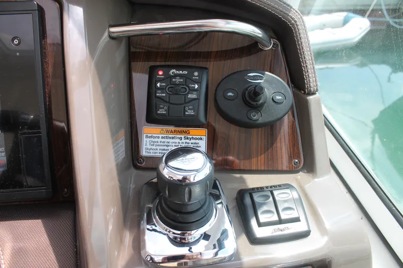 Slide: The Image of Control panel of 2014 Cruisers Yachts 350 Express with joystick and warning label. - 18