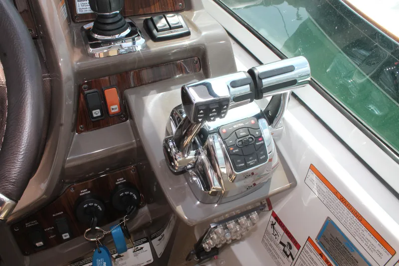 Slide: The Image of Control panel of 2014 Cruisers Yachts 350 Express with throttle and switches. - 19
