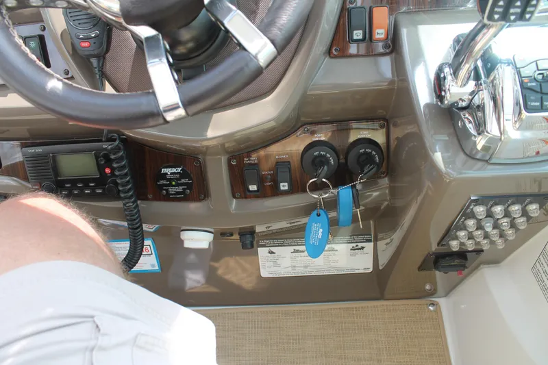 Slide: The Image of 2014 Cruisers Yachts 350 Express dashboard with controls and key fob. - 20