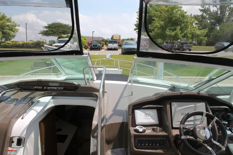 Slide: The Image of 2014 Cruisers Yachts 350 Express boat interior with dashboard and open cabin view. - 21