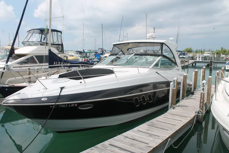 Slide: The Image of 2014 Cruisers Yachts 350 Express docked at a marina, surrounded by other boats. - 3