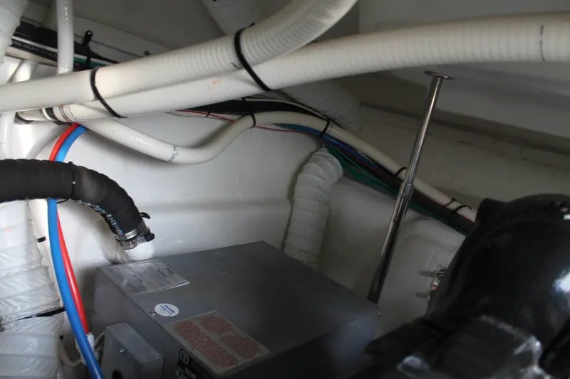 Slide: The Image of Engine compartment of 2014 Cruisers Yachts 350 Express with visible wiring and hoses. - 31