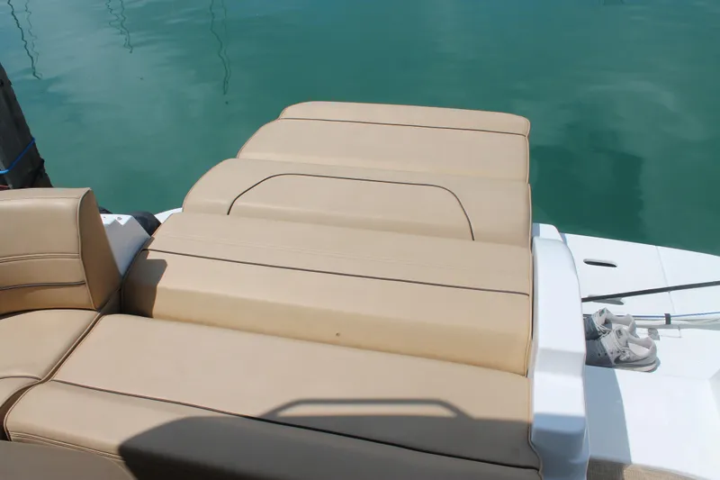 Slide: The Image of 2014 Cruisers Yachts 350 Express sunpad on turquoise water. - 32