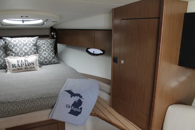 Slide: The Image of 2014 Cruisers Yachts 350 Express cabin with cozy bed and Elk Rapids decor. - 37