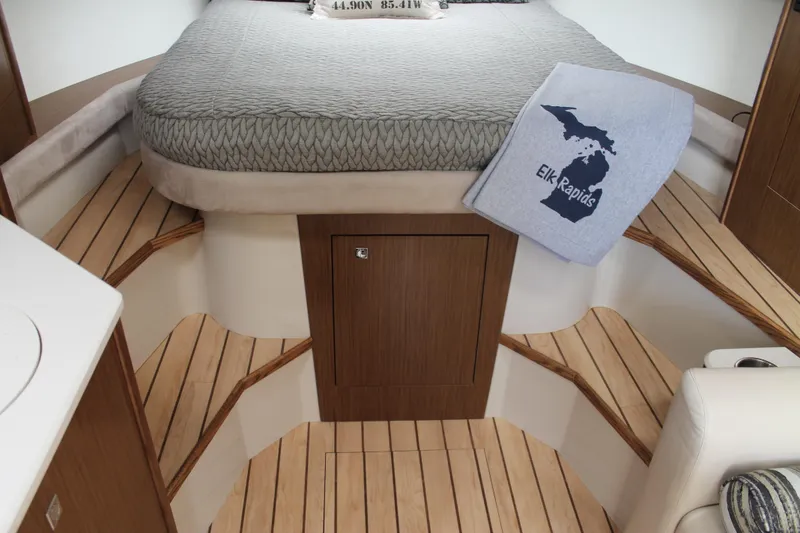 Slide: The Image of 2014 Cruisers Yachts 350 Express cabin interior with bed and Elk Rapids blanket. - 38