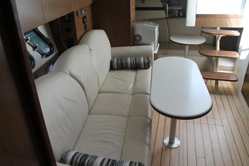 Slide: The Image of 2014 Cruisers Yachts 350 Express interior with beige sofa and wooden flooring. - 40