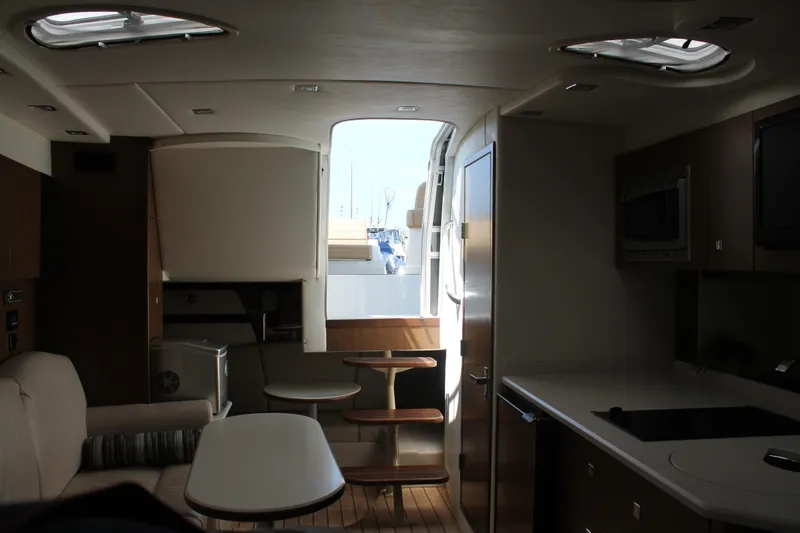 Slide: The Image of Interior of 2014 Cruisers Yachts 350 Express, featuring modern kitchen and seating area. - 41