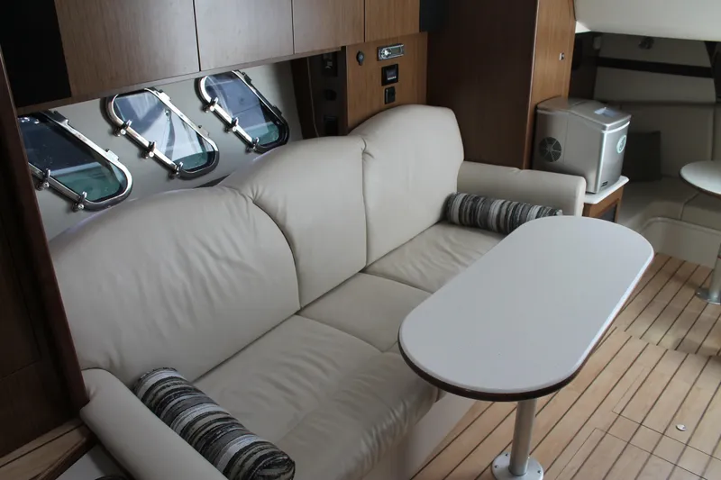 Slide: The Image of Interior of 2014 Cruisers Yachts 350 Express with beige sofa and table. - 42