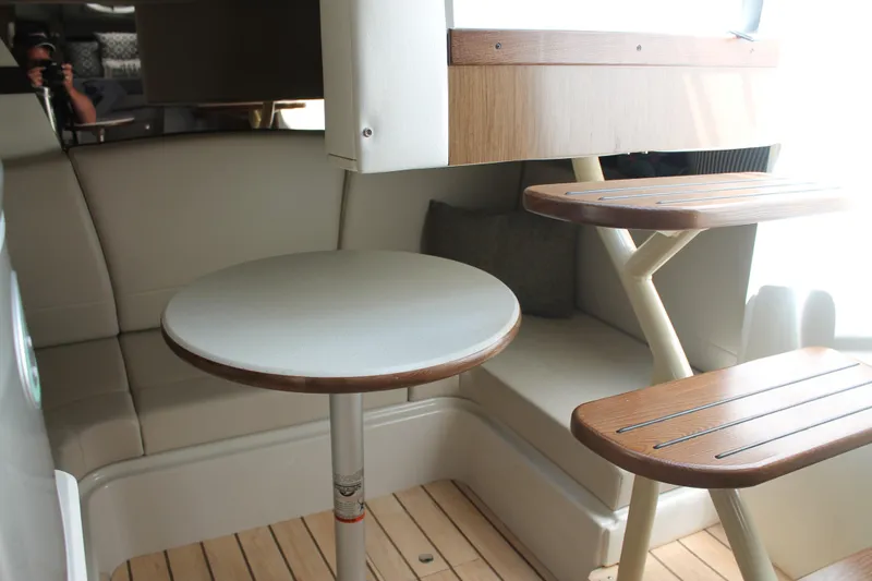 Slide: The Image of Interior of 2014 Cruisers Yachts 350 Express with seating, table, and wooden steps. - 43
