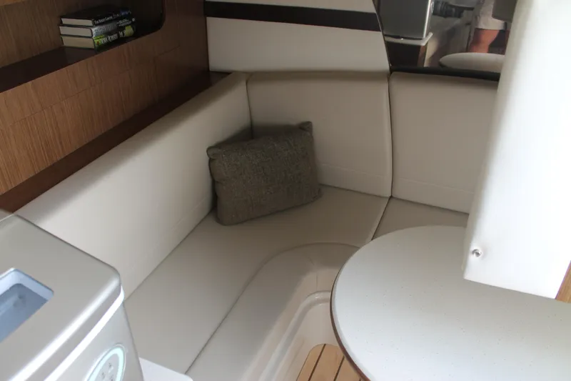 Slide: The Image of 2014 Cruisers Yachts 350 Express interior with beige seating and table. - 46