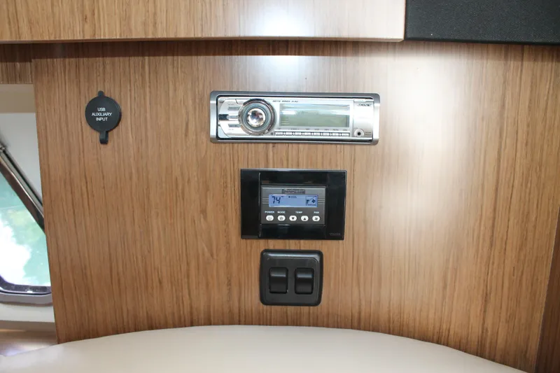 Slide: The Image of Control panel on 2014 Cruisers Yachts 350 Express with audio system and switches. - 48