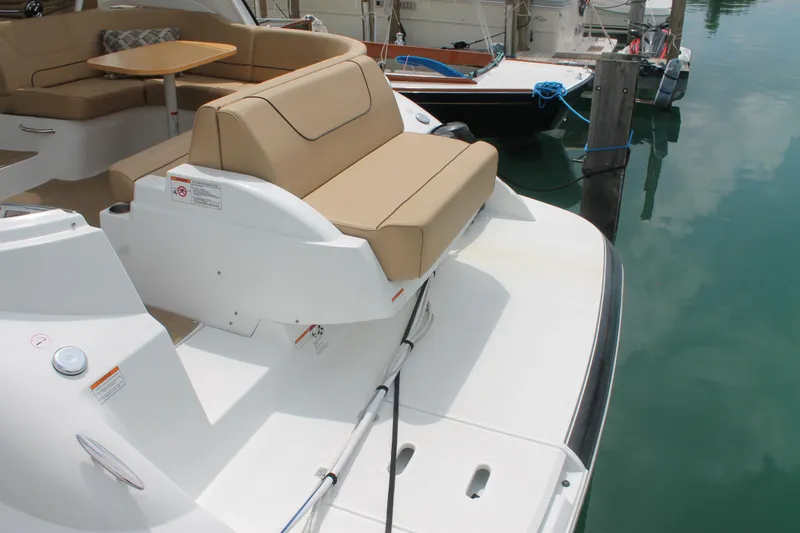 Slide: The Image of 2014 Cruisers Yachts 350 Express, rear seating area, docked in marina. - 5
