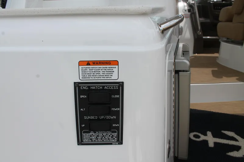 Slide: The Image of Control panel on 2014 Cruisers Yachts 350 Express, featuring engine hatch access and sunbed controls. - 6