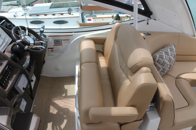 Slide: The Image of Luxurious interior of 2014 Cruisers Yachts 350 Express with beige seating and helm. - 9