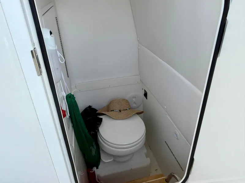 Slide: The Image of 2023 Regulator 23 boat interior with compact marine toilet and accessories. - 14