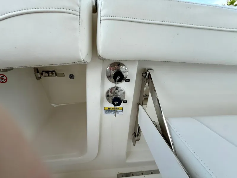 Slide: The Image of 2023 Regulator 23 boat interior with white seating and control knobs. - 17