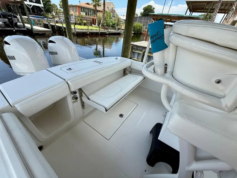 Slide: The Image of 2023 Regulator 23 boat interior with seating and dual Yamaha engines. - 18