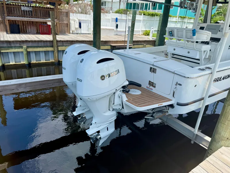 Slide: The Image of 2023 Regulator 23 boat with dual Yamaha outboard engines docked in marina. - 8