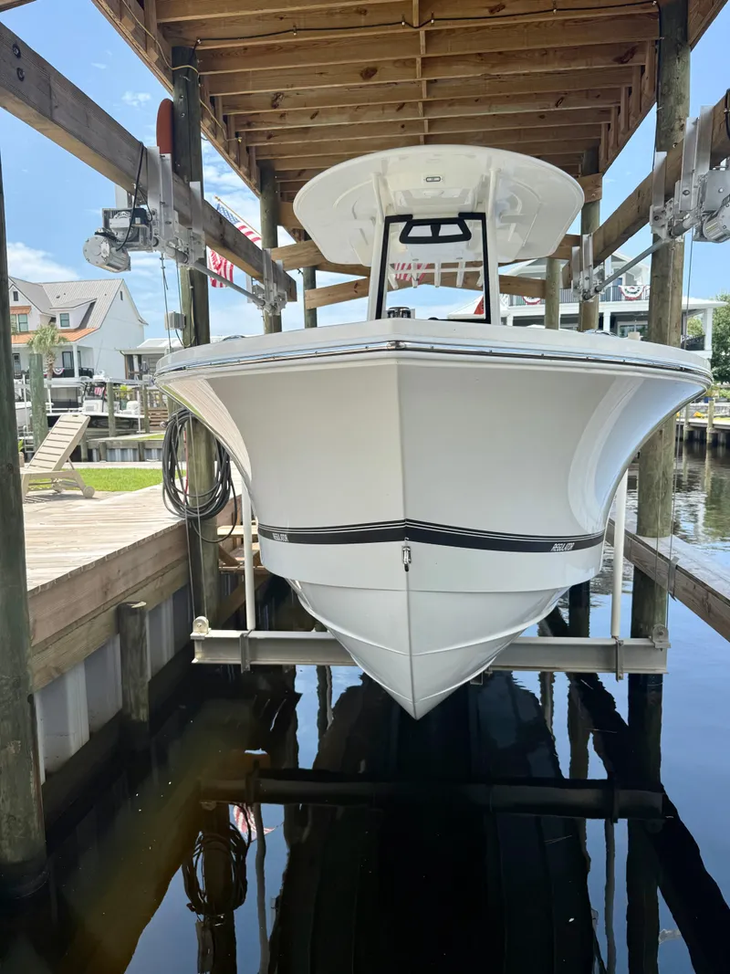 Slide: The Image of 2023 Regulator 23 boat docked in a covered marina slip. - 9