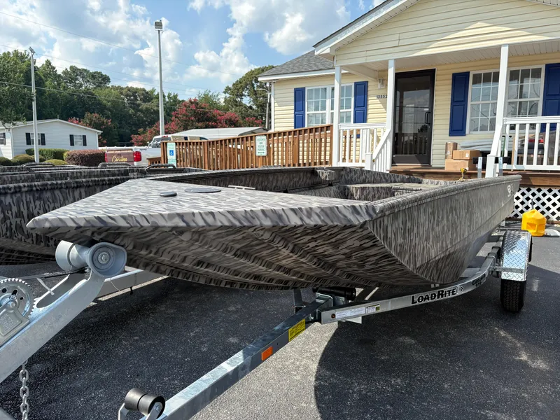 Slide: The Image of 2025 Edge Duck Boats Standard 656DB on trailer, parked outside a building under a cloudy sky. - 0