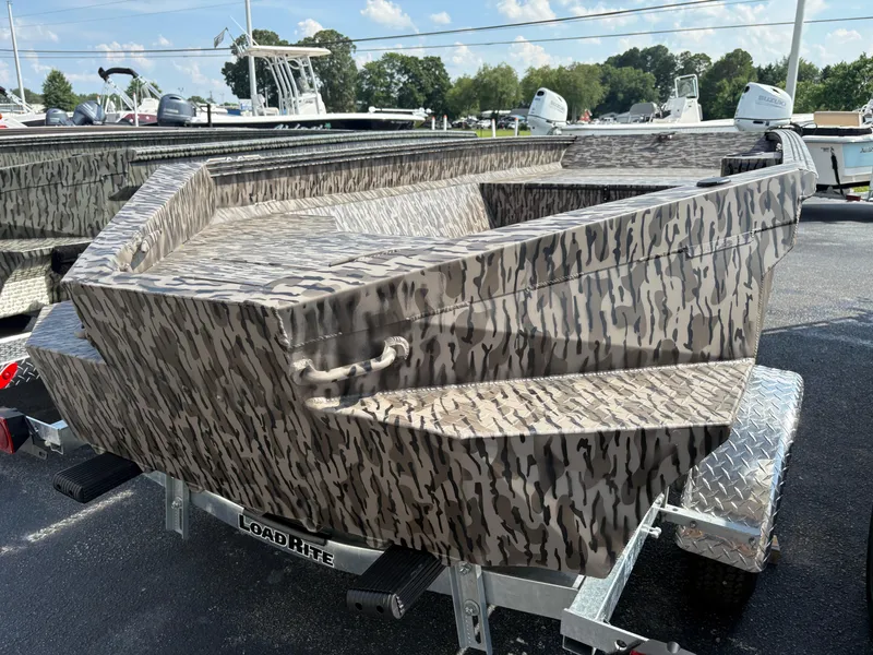 Slide: The Image of 2025 Edge Duck Boats Standard 656DB with camouflage design on a trailer. - 2