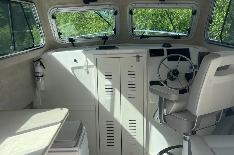 Slide: The Image of Interior of 2020 Parker 2530 Extended Sport Cabin with steering wheel and seating. - 10