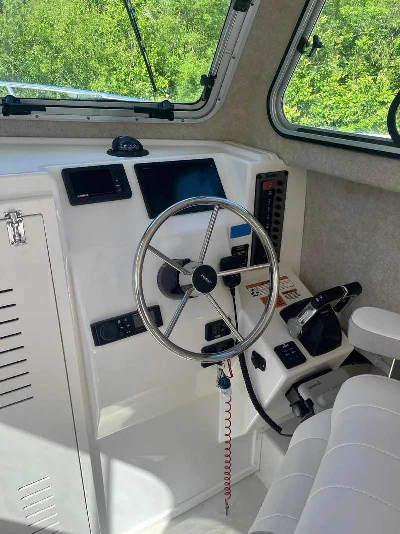 Slide: The Image of Cabin interior of 2020 Parker 2530 Extended Sport, featuring steering wheel and control panel. - 5