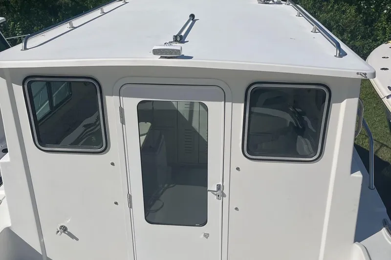 Slide: The Image of 2020 Parker 2530 Extended Sport Cabin boat, white exterior, viewed from above. - 8