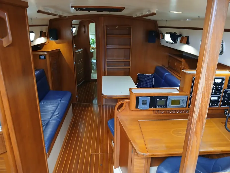 Slide: The Image of Interior of 1999 Island Packet 45 yacht with wood finish and blue seating. - 12