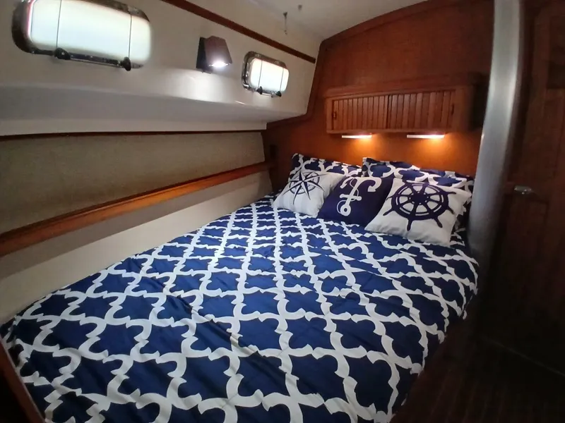 Slide: The Image of Cozy cabin interior of 1999 Island Packet 45 sailboat with nautical-themed bedding. - 17
